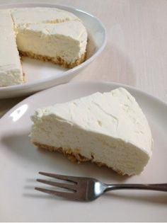 a piece of cheesecake on a plate with a fork next to it and another slice missing