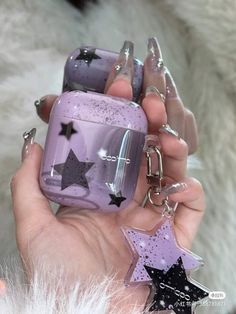 a hand holding a purple case with stars on it