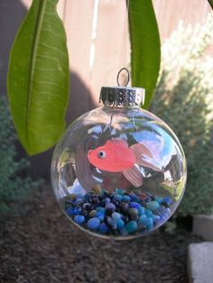 an ornament hanging from a tree filled with fish