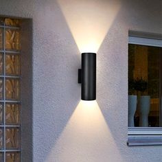 a modern outdoor wall light on the side of a house