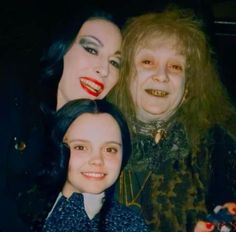 two women and one man are posing for a photo with their faces painted like witches