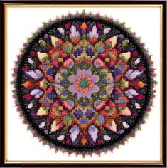 a cross - stitch pattern in the shape of a circle with flowers and leaves on it