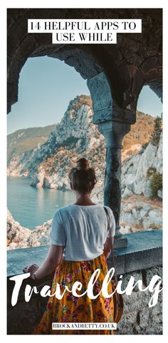 a woman looking out at the ocean and mountains