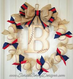 a baseball wreath with the letter b on it and red white and blue ribbons around it