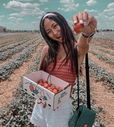 a woman holding an apple in her hand