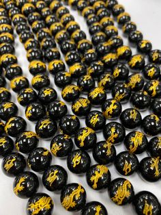 black and yellow marble beads on white surface