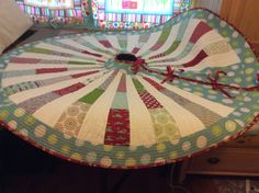 a quilted table top sitting on top of a wooden dresser next to a window