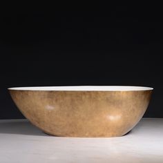 a large golden bowl sitting on top of a white counter