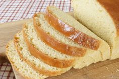 sliced loaf of bread sitting on top of a wooden cutting board