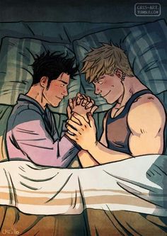 two young men laying in bed with their hands together, one holding the other's hand