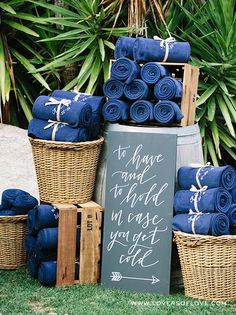 the bride's blue towels are stacked on top of each other in wicker baskets