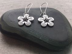 "Here are some pretty and unique flower dangle earrings. They are so sweet and would be perfect for everyday wear. Theses earrings would also make the perfect little gift for someone special. Made from allergy free plated silver. They measure 5/8\" across by 5/8\" long and hang from 1\" kidney style ear wires. Overall length is 1 5/8\" long. I have a matching necklace in my store if you would like the whole set. Here is a direct link https://etsy.me/317bnO3 Thanks for stopping by! Please take a Whimsical Adjustable Flower Charm Earrings, Whimsical Flower Charm Earrings, Whimsical Flower-shaped Earrings With Flower Charm, Bohemian Hypoallergenic Flower Earrings, Whimsical Nickel Free Dangle Flower Earrings, Bohemian Flower Charm Drop Earrings, Whimsical Flower Earrings, Whimsical Drop Earrings With Flower Charm, Bohemian Flower Earrings Nickel Free