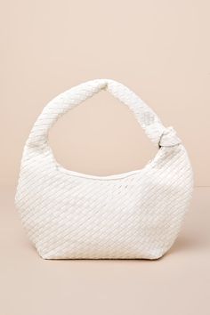 From work-filled weekdays to busy weekends, the Billini Kenya Bone Woven Knotted Shoulder Bag is ideal for the girls who have a lot to do (and want to look good doing it)! Woven vegan leather shapes this too-cute bag that features a flexible, oversized silhouette with a flat bottom design and a knotted shoulder strap. The zippered top opens to reveal an extra-roomy, lined interior with a zipper pocket and a sidewall pouch. Lined. Bag measures 15. 25" wide, 8. 25" tall, and 4. 5" deep (relaxed). Knot Bag, Bottom Design, Oversized Silhouette, Woven Bag, The Girl Who, Cute Bag, White Bag, Vegan Friendly, Handbag Accessories