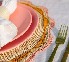 a close up of a plate with napkins and forks on it next to a fork