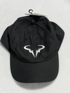 a black hat with white lightning bolt on the front and back, hanging from a hook