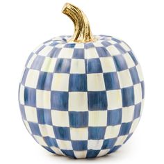 a blue and white checkered pumpkin sitting on top of a white surface with gold trim