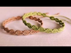 three braided bracelets sitting next to each other