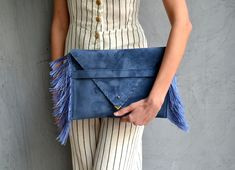 "Medusa Clutch in raf blue. An adorable leather clutch with fringes for beautiful fashion looks. This envelope clutch is ideal to carry anything you might need! A handmade clutch from Italian genuine suede leather in raf blue colour and silk fringes. The interior is fully lined with gray leatherette. It closes with one metal rivet stud in silver or gold. The pictures show the clutch with gold stud. Dimensions: Height 23 cm (9,06\"), Length 32 cm (12,6\") Do you want to use your clutch as a shoul Blue Clutch Bag, Envelope Clutch Purse, Leather Envelope Clutch, Blue Leather Bag, Leather Fringe Bag, Blue Clutch, Velvet Clutch, Leather Clutch Purse, Leather Envelope