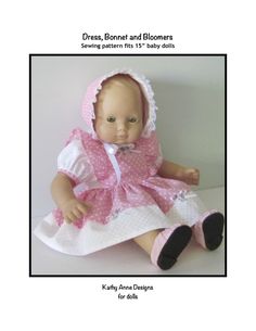 a baby doll wearing a pink dress and bonnet