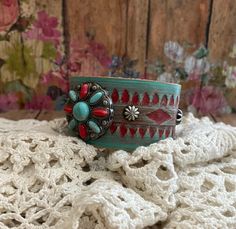 v'¯) .`*.¸.*' ❤ CONCHO COLLECTION ❤ ¸.*'.*'¨) ¸. (¸.*'(¸.*' (¸. My leather concho cuff bracelets will add a rustic feminine touch to your look! Each made from tooled leathers & beautifully detailed conchos. Filigrees and rivets add dimension. They can be dressed up or down to compliment any outfit. Buy it ---- Wear It----Make it your own! This DESIGN ~ ❤ Beautiful red & turquoise flower concho. ❤ Hand painted tooled leather in multiple layers to achieve this unique color, distressed and sealed. Artisan Red Adjustable Cuff Bracelet, Adjustable Artisan Red Cuff Bracelet, Adjustable Red Artisan Cuff Bracelet, Bohemian Concho Cuff Bracelet As Gift, Handmade Southwestern Red Cuff Bracelet, Handmade Red Southwestern Cuff Bracelet, Red Southwestern Cuff Bracelet Gift, Red Southwestern Cuff Bracelet As Gift, Adjustable Red Bohemian Cuff Bracelet