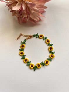 Pretty sunflower design  encompassed in anklet  Yellow and green glass seed beads Chocolate glass pearl bead centers finished with lobster clasp & extension chain and charm Length option available  shipping Free delivery on all uk orders International is by Airmail,please see listings for time scale I am not a big business but a one woman operation. I pride myself with attention to detail and strive to offer a swift and efficient service. If anything is not to your complete satisfaction I would appreciate to be given the opportunity to put it right BEFORE feedback is left. Any problems: Please send me a message before opening a case as most problems can be quickly & easily resolved . Yellow Seed Bead Bracelet, Yellow Dainty Jewelry For Summer, Dainty Yellow Jewelry For Summer, Dainty Yellow Summer Jewelry, Summer Flower Shaped Beaded Chain Jewelry, Green Beaded Bracelets For Summer, Green Beaded Chain Bracelets For Summer, Summer Yellow Beaded Bracelets With Tiny Beads, Summer Flower Jewelry With Tiny Beads