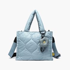 Loyalty bb tote: Cute, functional, & versatile as a crossbody. Puffy design with a quirky charm—daisy or egg? Features bottle holder & carabiner. Nylon Puffy Design, Puffer Tote Bag, Daisy Charm, Winter Neutral, Blue Puffer, Quilted Tote Bags, Vegan Leather Handbag, Quilted Totes, Chic Bags