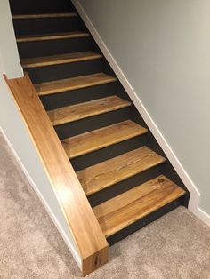 the stairs are made out of wood and have black treading