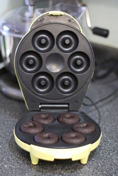 a waffle iron with chocolate donuts in it