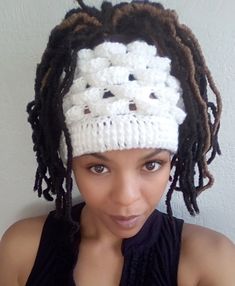 a woman wearing a crochet hat with dreadlocks