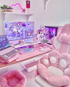 a desk with two laptops and a pink chair