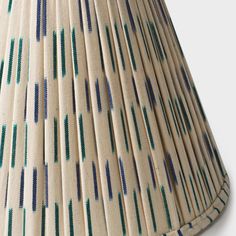 a lamp shade with blue and green stripes on it