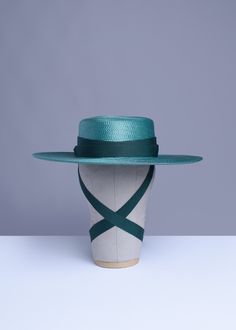 This full-size teal green faux straw hat is trimmed with complimentary green grosgrain ribbon. Ribbon ends are trimmed with matching green tassels. Nice and structured, not floppy, with a wide brim. Inspired by my dear friend Samantha Rei. Fits up to a 23" head size. Material: 100% Polypropylene Crown Width: 6.5 inch Crown Height: 3.25 inch Brim Width: 4 inch Ships in a hat box. This item is OVERSIZED so unfortunately International and Priority shipping will be quite high. All pieces are MADE TO Green Hat Bands For Kentucky Derby, Green Fedora For Kentucky Derby, Fitted Green Fedora For Kentucky Derby, Green Fedora With Curved Brim For Spring, Green Boater Hat With Flat Brim For Summer, Green Summer Boater Hat With Flat Brim, Green Flat Brim Boater Hat For Summer, Adjustable Green Hat Band For Kentucky Derby, Green Adjustable Hat Bands For Kentucky Derby