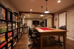 a room that has a pool table in the center and many books on the shelves