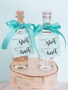 two bottles with labels on them that say, take a shot we tied the knot