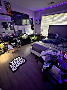 a bed room with a neatly made bed and purple lighting