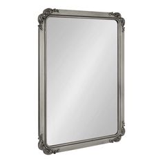 a large mirror with an ornate frame on the front and bottom edge, in silver