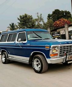 an old blue station wagon parked on the street