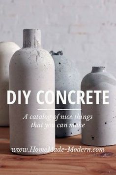 three white vases sitting next to each other on top of a wooden table with the words diy concrete