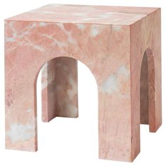 a pink marbled stool with an arch at the top