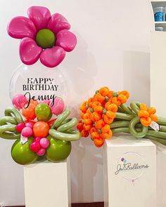 two vases with flowers and balloons on them