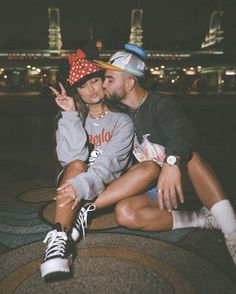 a man and woman sitting next to each other in front of a cityscape