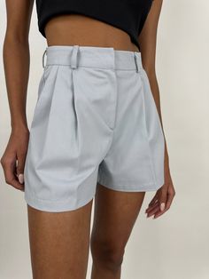 A pleated wide leg trouser short with a hook and eye closure and belt loops. Canvas like material with no stretch. If you are in between sizes, we suggest sizing up for a more mid rise, comfortable fit. Size XSmall measures 24 1/2" in the waist with a 2 1/2” inseam.Size Medium measures 29” in the waist with a 2 1/2” inseam. 100% Cotton. Jordyn is wearing size XSmall high rise. Connor is wearing size Medium mid rise. Refer to our Size Chart for Model Measurements. Questions about fit? Text us any Trouser Shorts, Womens Clothing Stores, High Waisted Shorts, Model Measurements, Business Women, Mid Rise, High Rise, Comfort Fit, Wide Leg