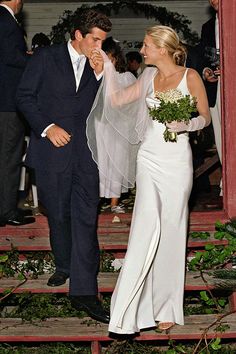 the bride and groom are walking down the steps