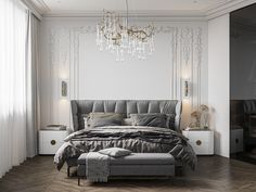 a bedroom with white walls and wood flooring has a large bed in the center