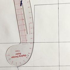 a ruler is on top of a piece of paper that has been cut in half