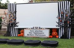 there is a sign that says now playing the nightmare before christmas with pumpkins on it