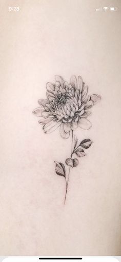 a black and white photo of a flower on the back of a woman's stomach