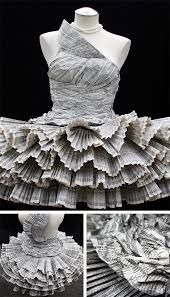 the dress is made out of newspapers and has ruffles on it's skirt