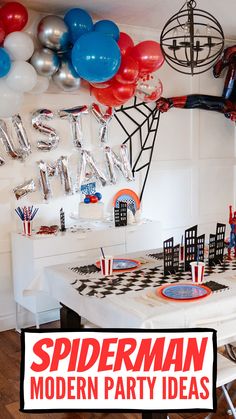 a spiderman birthday party with balloons and streamers on the ceiling, including red white and blue decorations