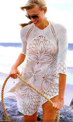 a woman holding a rope on the beach